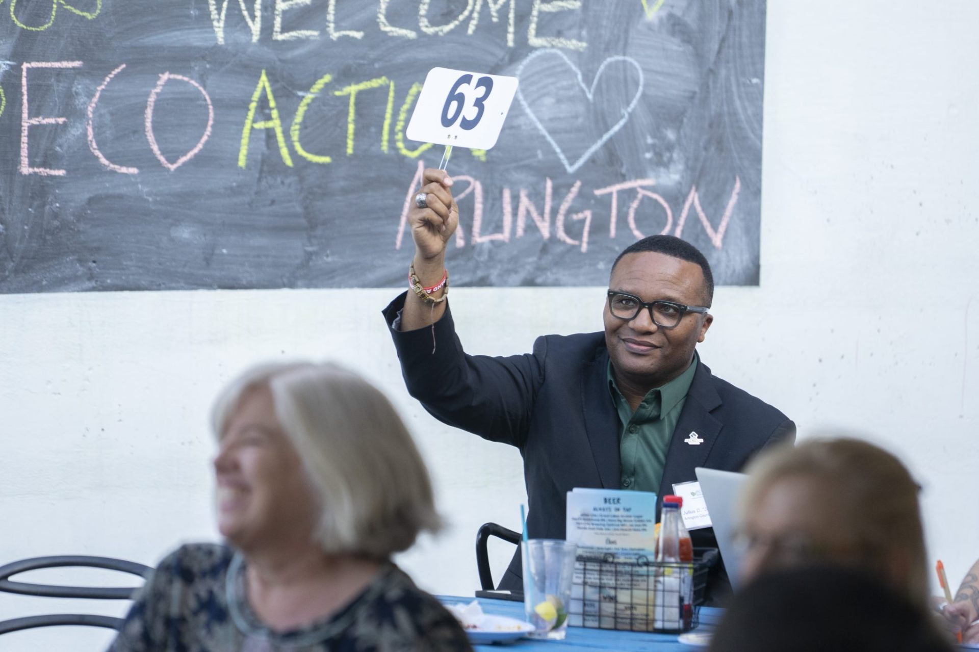 EcoAction Arlington bidder raising paddle 63