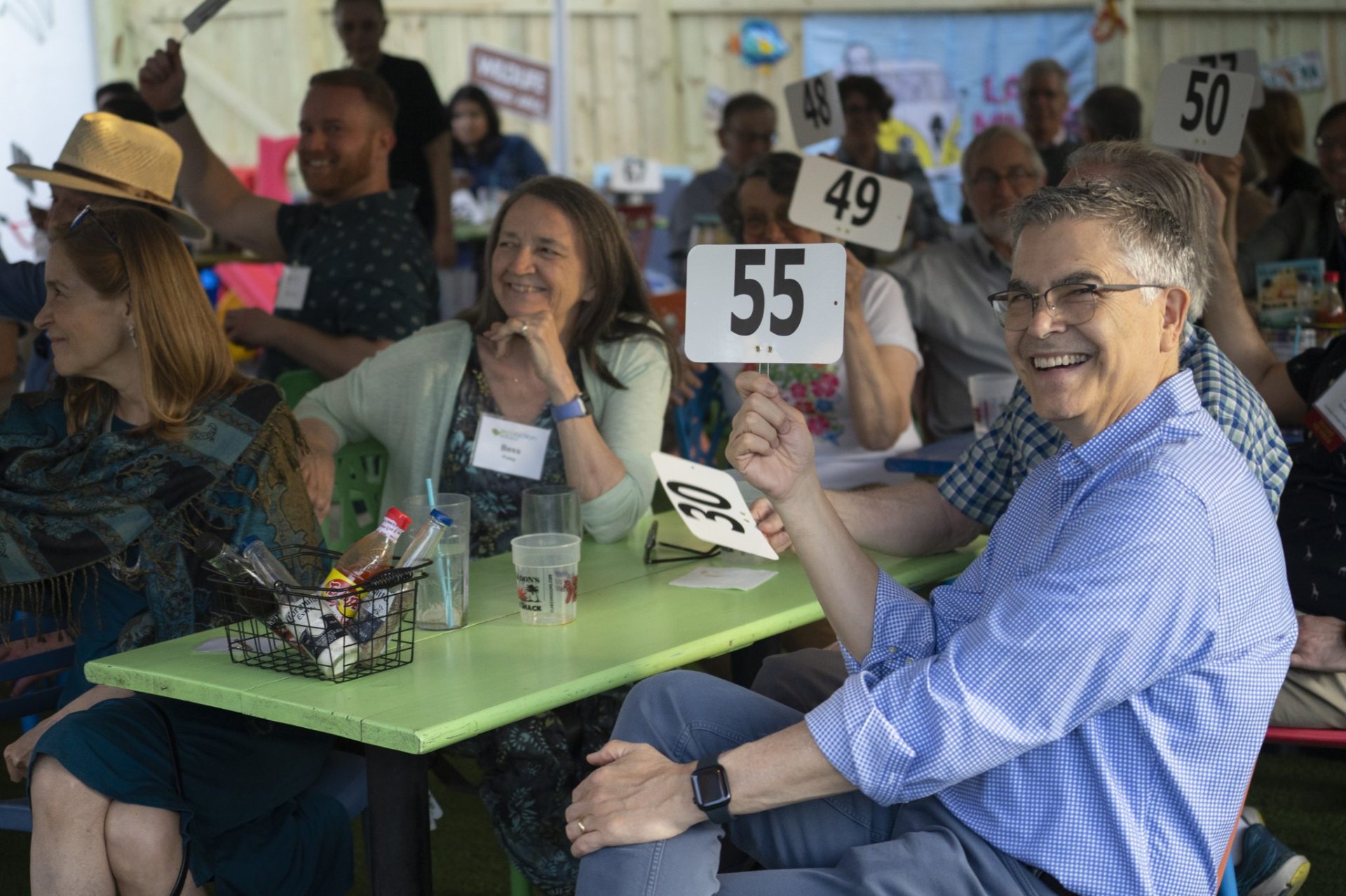 EcoAction Arlington donors laughing with paddles up